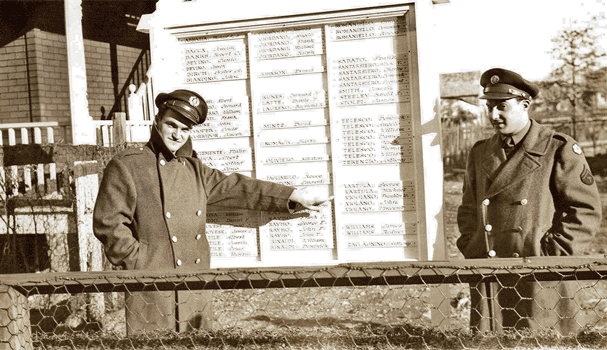 Dan and Jim Genovese in front of honor roll