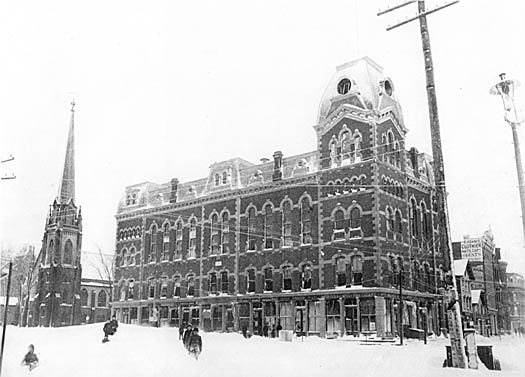 Children slide in the snow outside the Old Town Hall