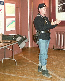 Guy DeMasi demonstrating soldier's gear