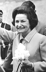 Lady Bird Johnson waving to the crowd